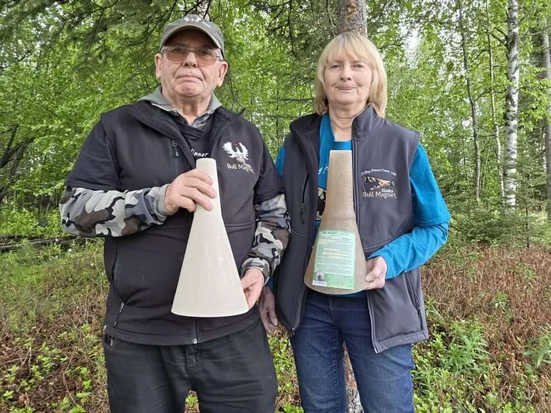 Wayne and Marilyn Kubat holding Bull Magnet moose calls in Wasilla, Alaska